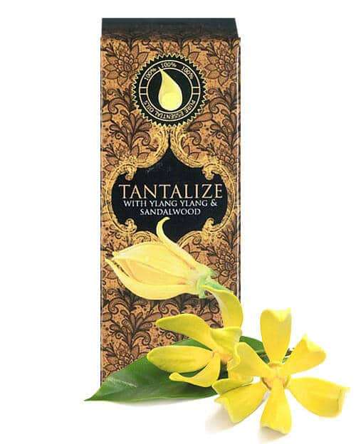 essential oil for love - wildfire tantalize 10ml essenial oil box with ylang ylang flower in the foreground