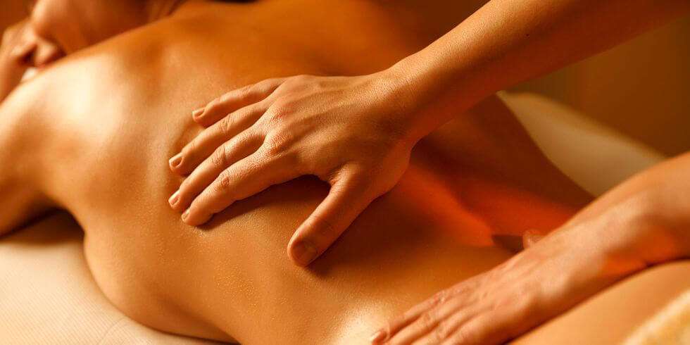 erotic massage with oil and hands on woman's back